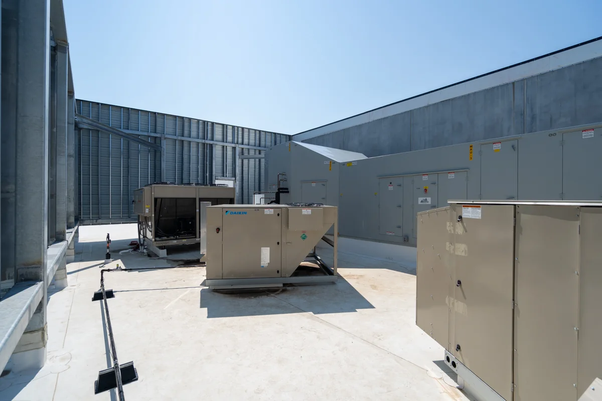 Wide view of multiple rooftop HVAC units and makeup-air equipment.