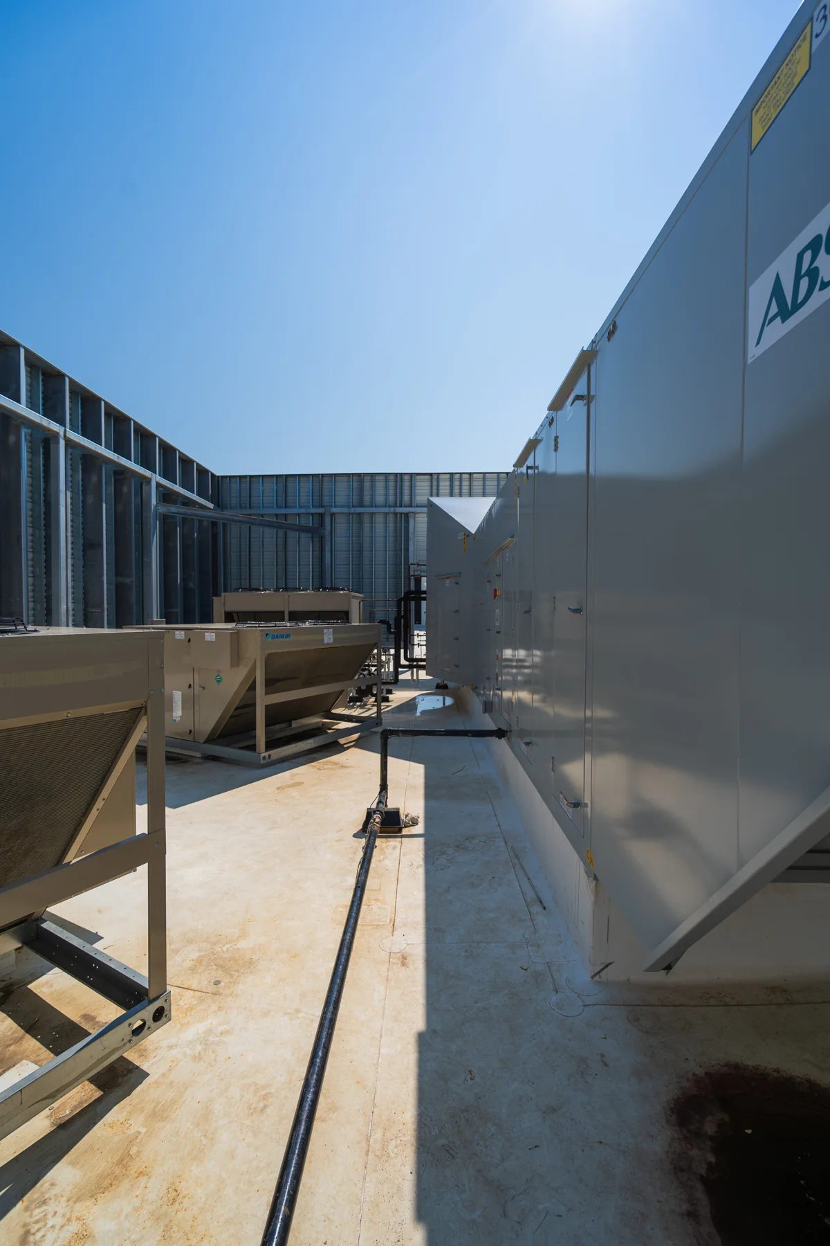 Rooftop makeup-air and HVAC equipment coordinated within the equipment yard.
